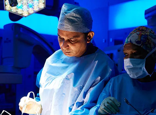 Professor Prokar Dasgupta operating in theatre with a member of the surgical team