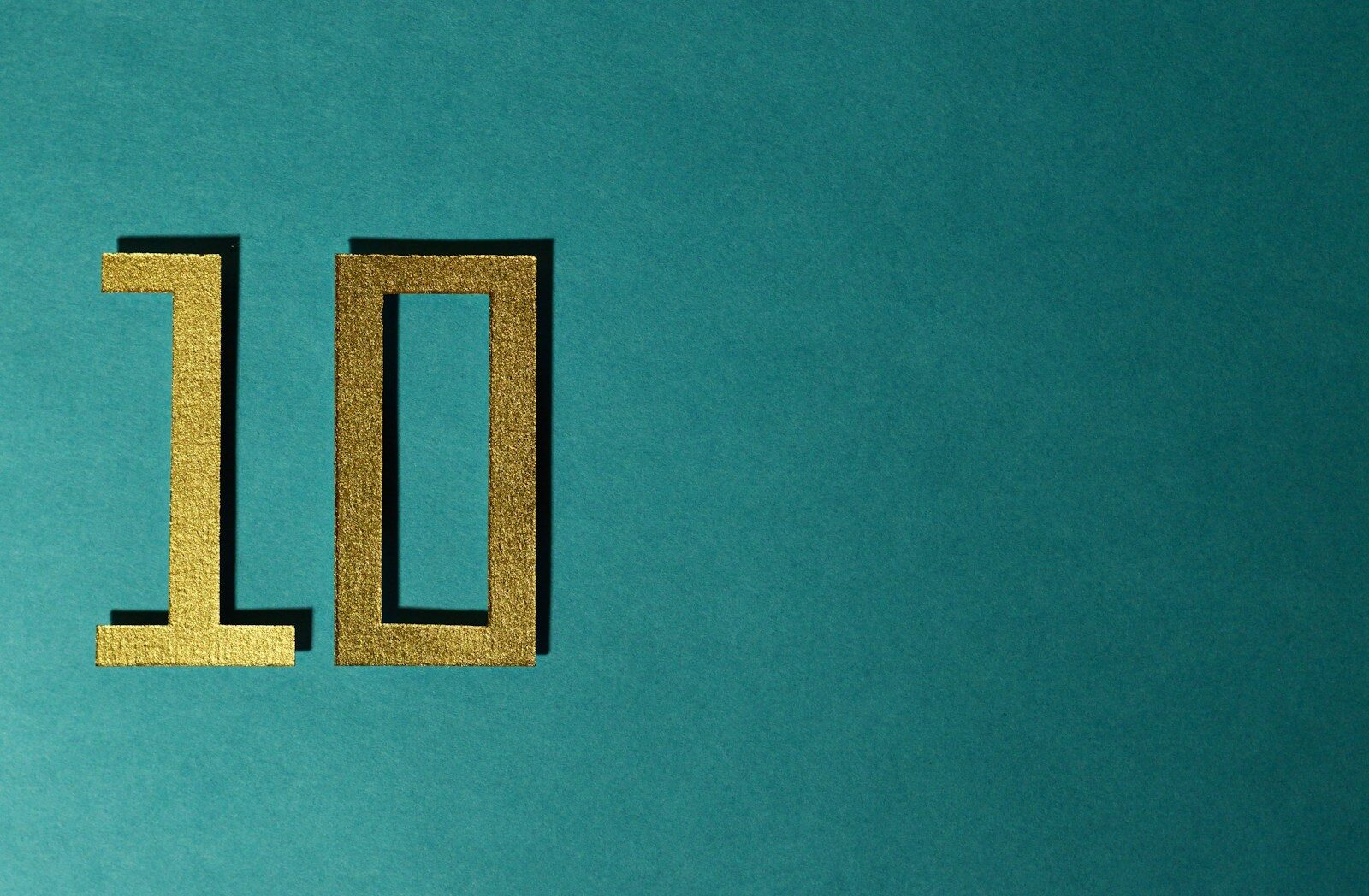 The number 10 is gold on a teal background.