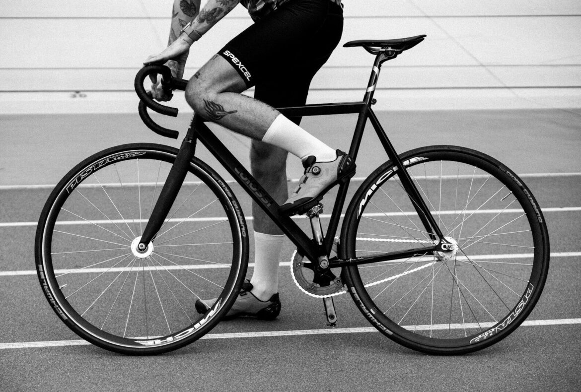 Photo by Kato Blackmore 🇺🇦 Cyclist riding on a track with a fixed gear bike.