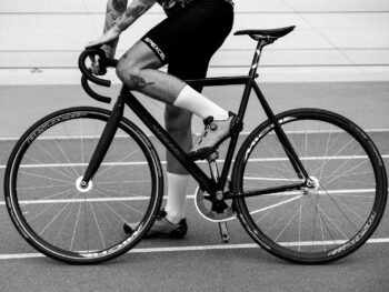 Cyclist riding on a track with a fixed gear bike.