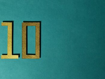 The number 10 is gold on a teal background.