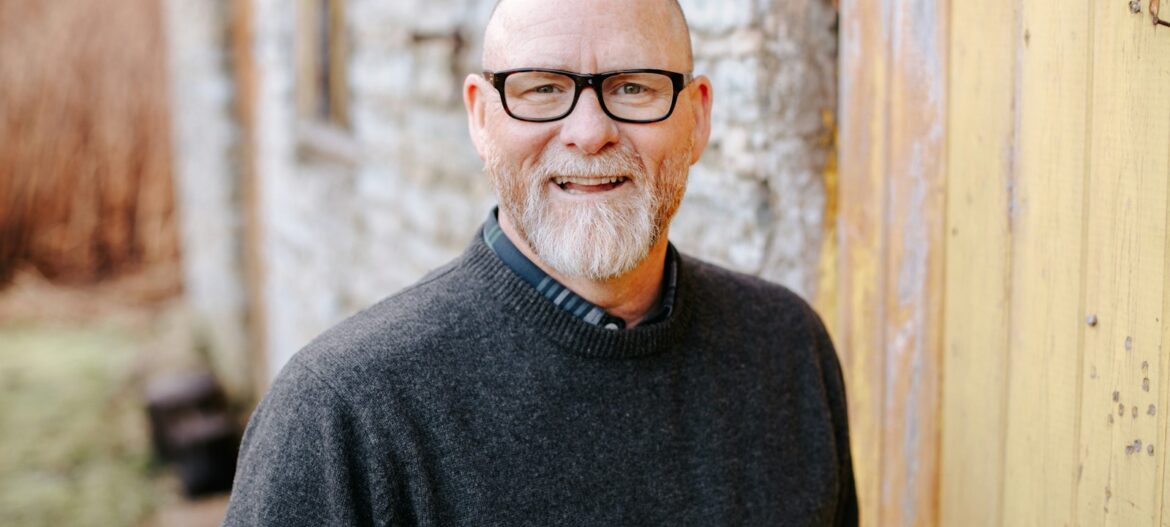 man in black crew neck sweater wearing black framed eyeglasses