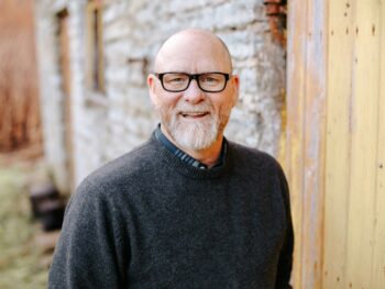 man in black crew neck sweater wearing black framed eyeglasses